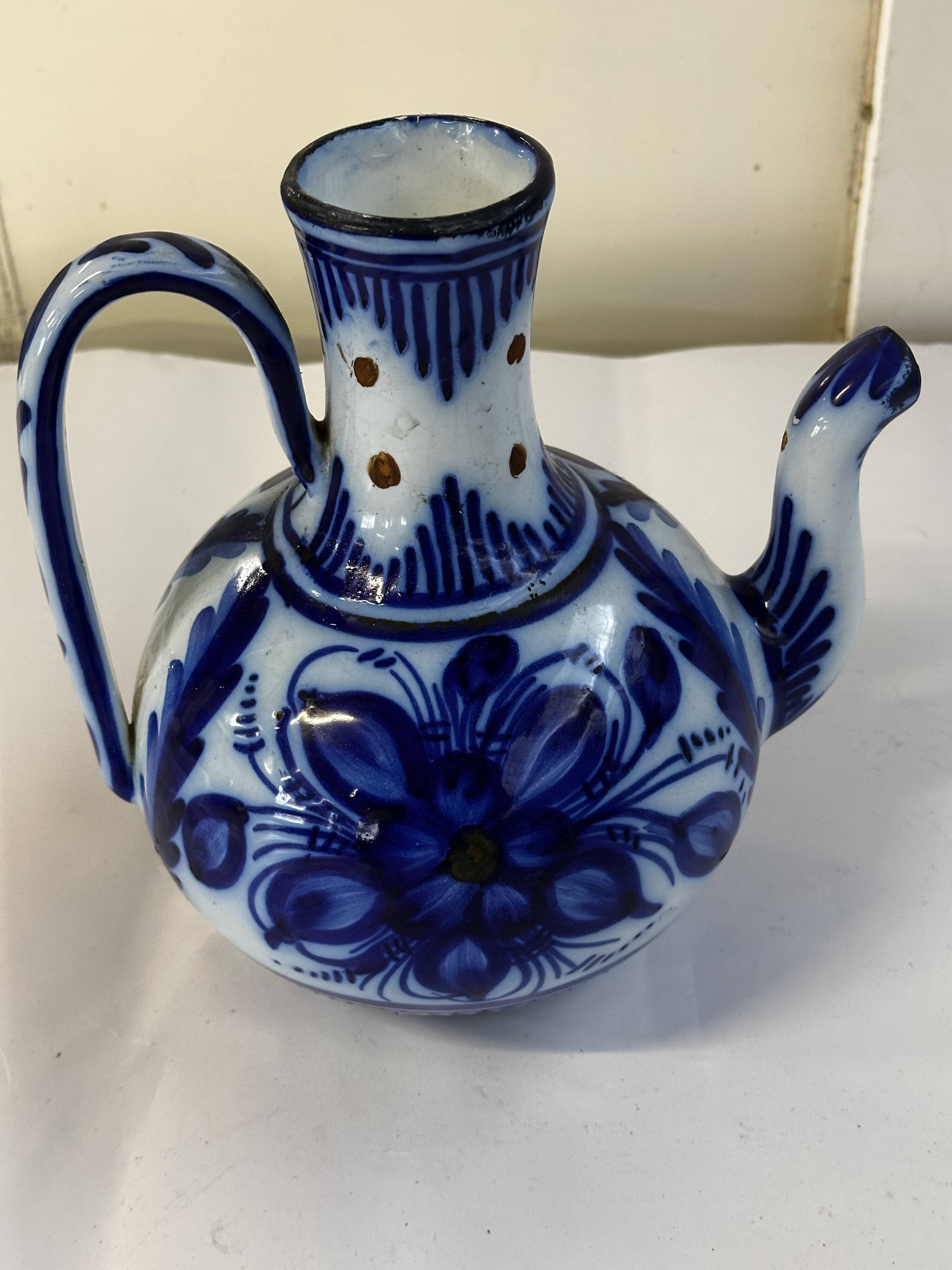 Glazed ceramic carafe with floral decoration