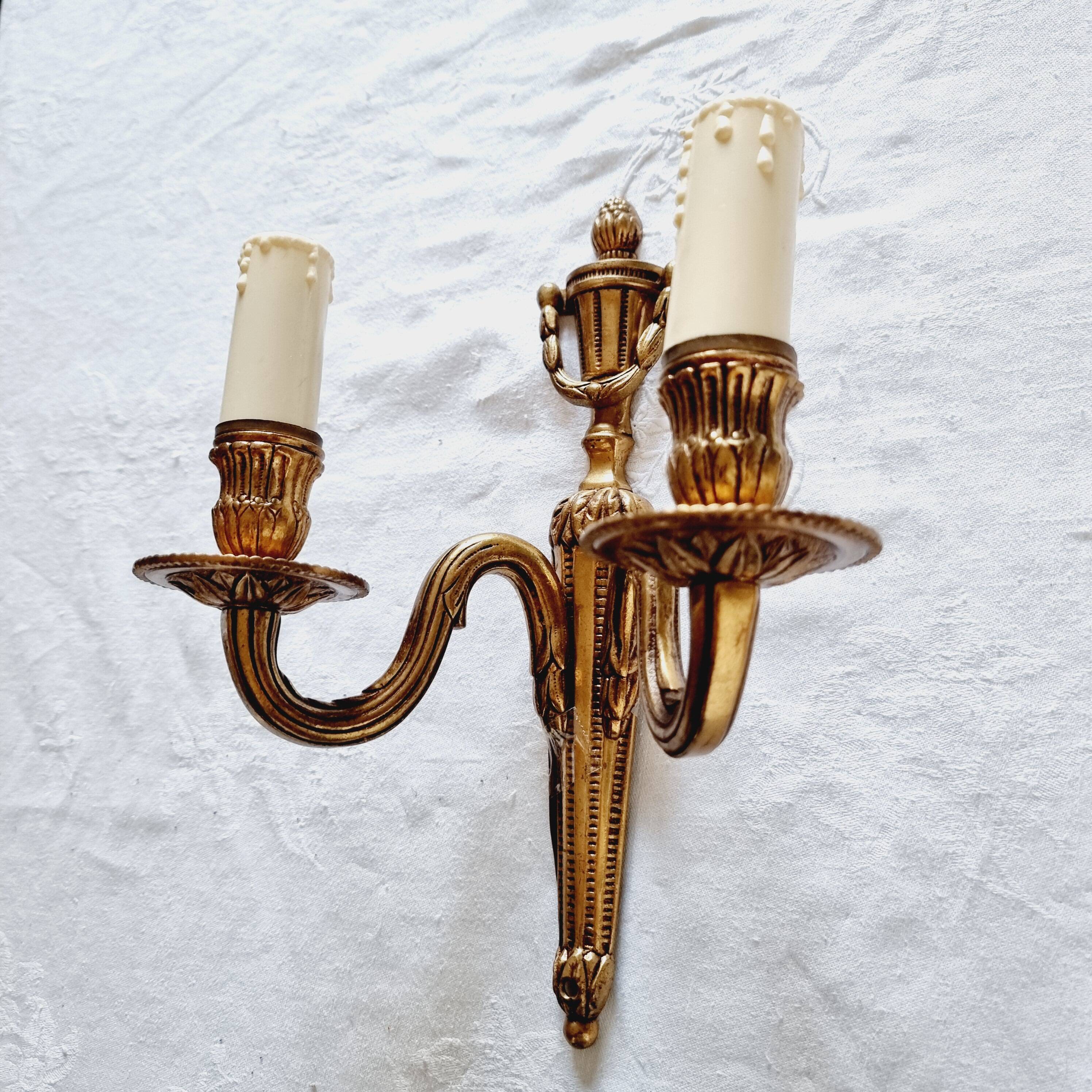 French Empire-style wall sconce or chandelier in bronze with an antique gold patina.