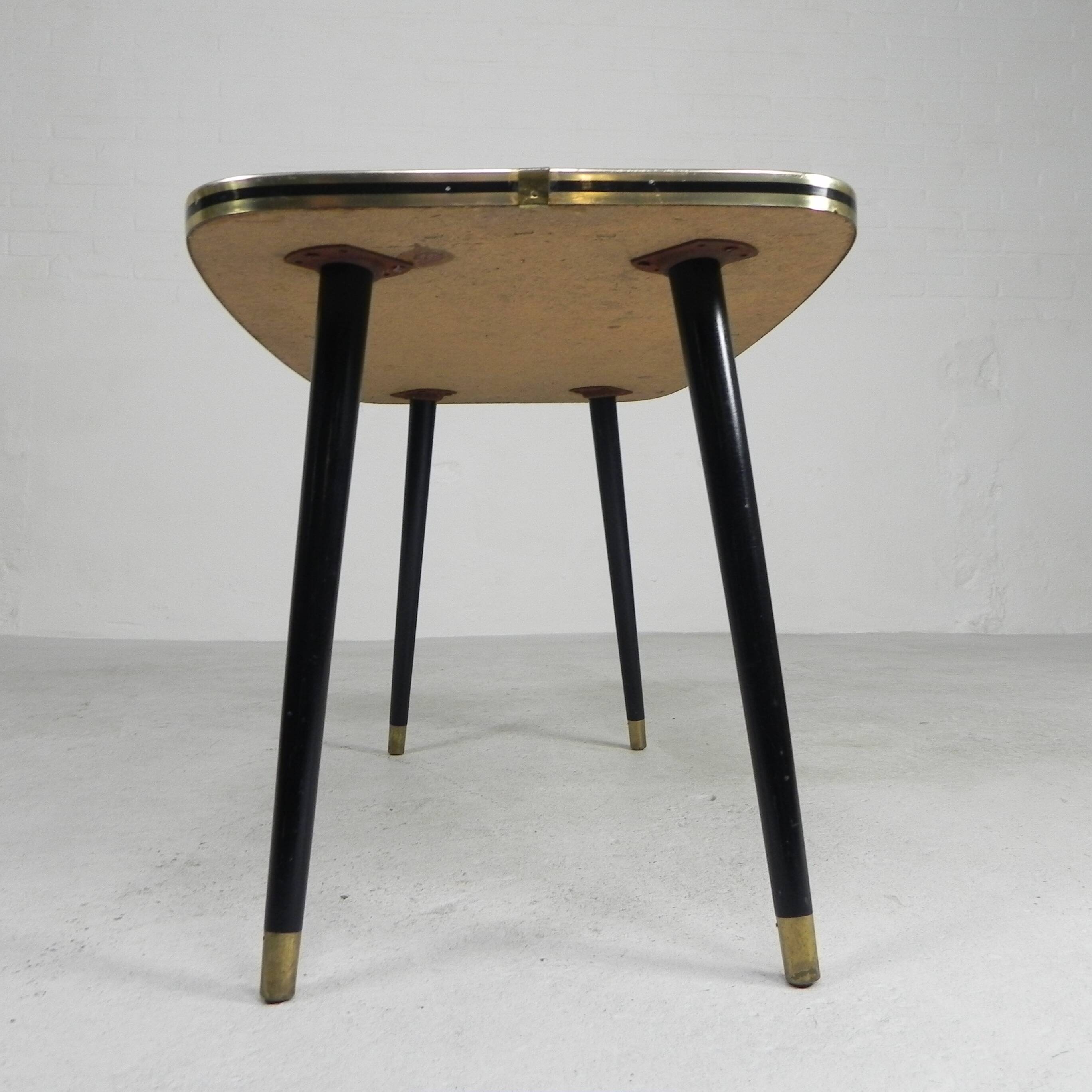 Vintage coffee table with glass top and angled legs