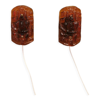 Wall lamps made of hard pressed amber colored glass. Produced by Danish Vitrika in the 70s