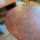 Oval extendable dining table in wood and walnut burl veneer.
