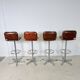 1970s chrome bar stools with cognac-colored faux leather upholstery