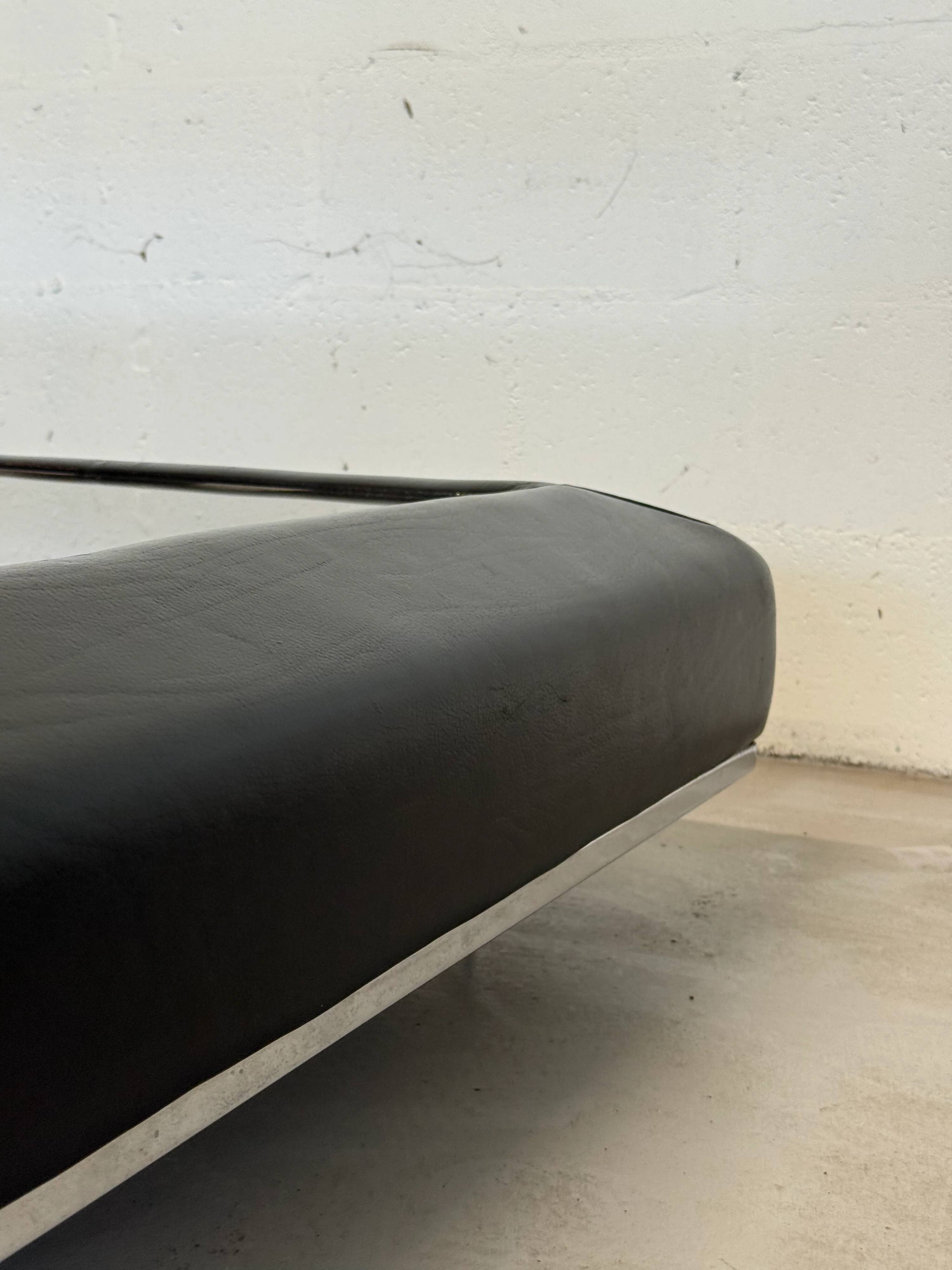 Vintage coffee table covered in leather, smoked mirror top and chrome legs.