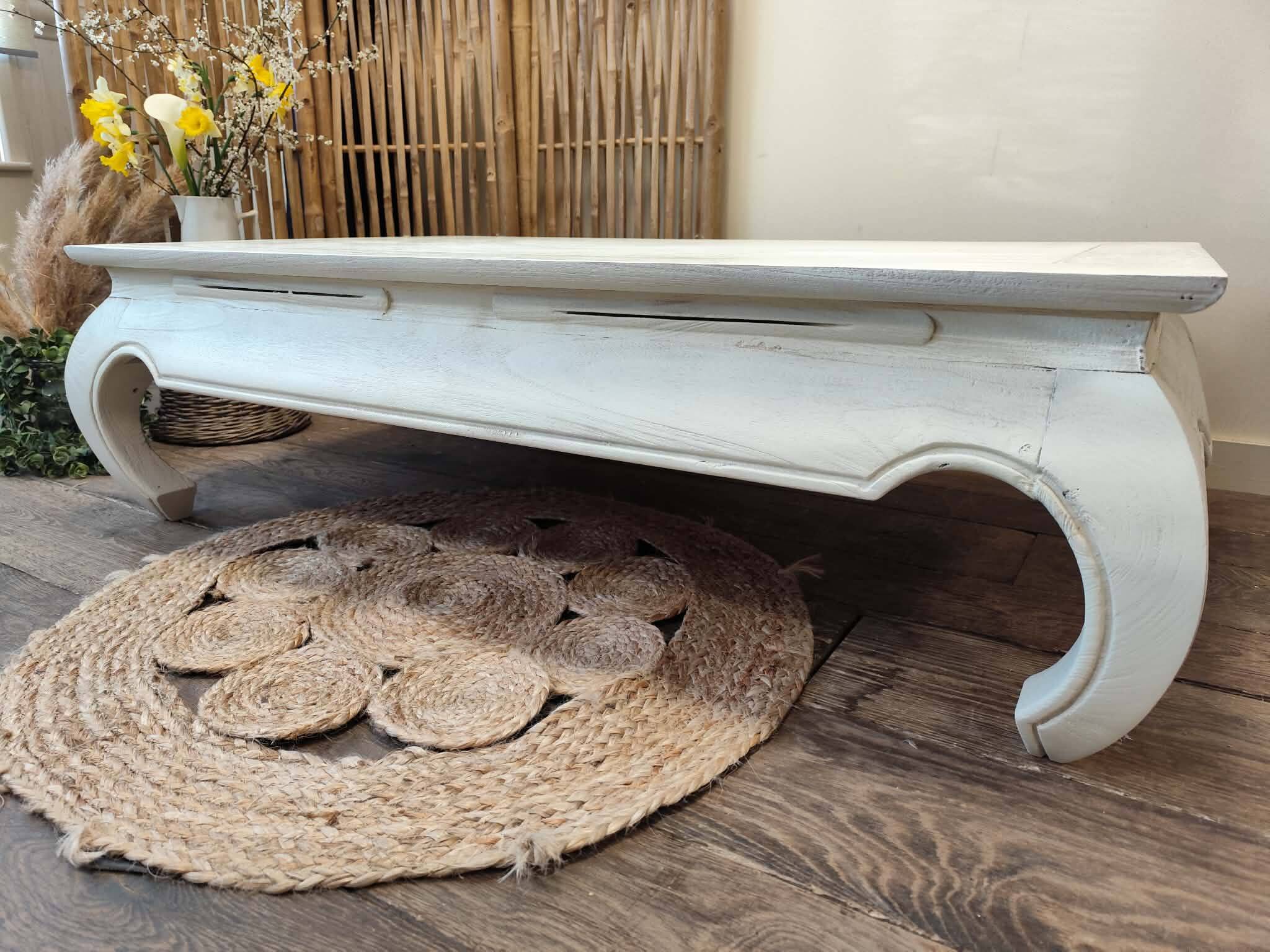 Exotic wood coffee table with its safety glass protection.