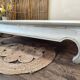 Exotic wood coffee table with its safety glass protection.