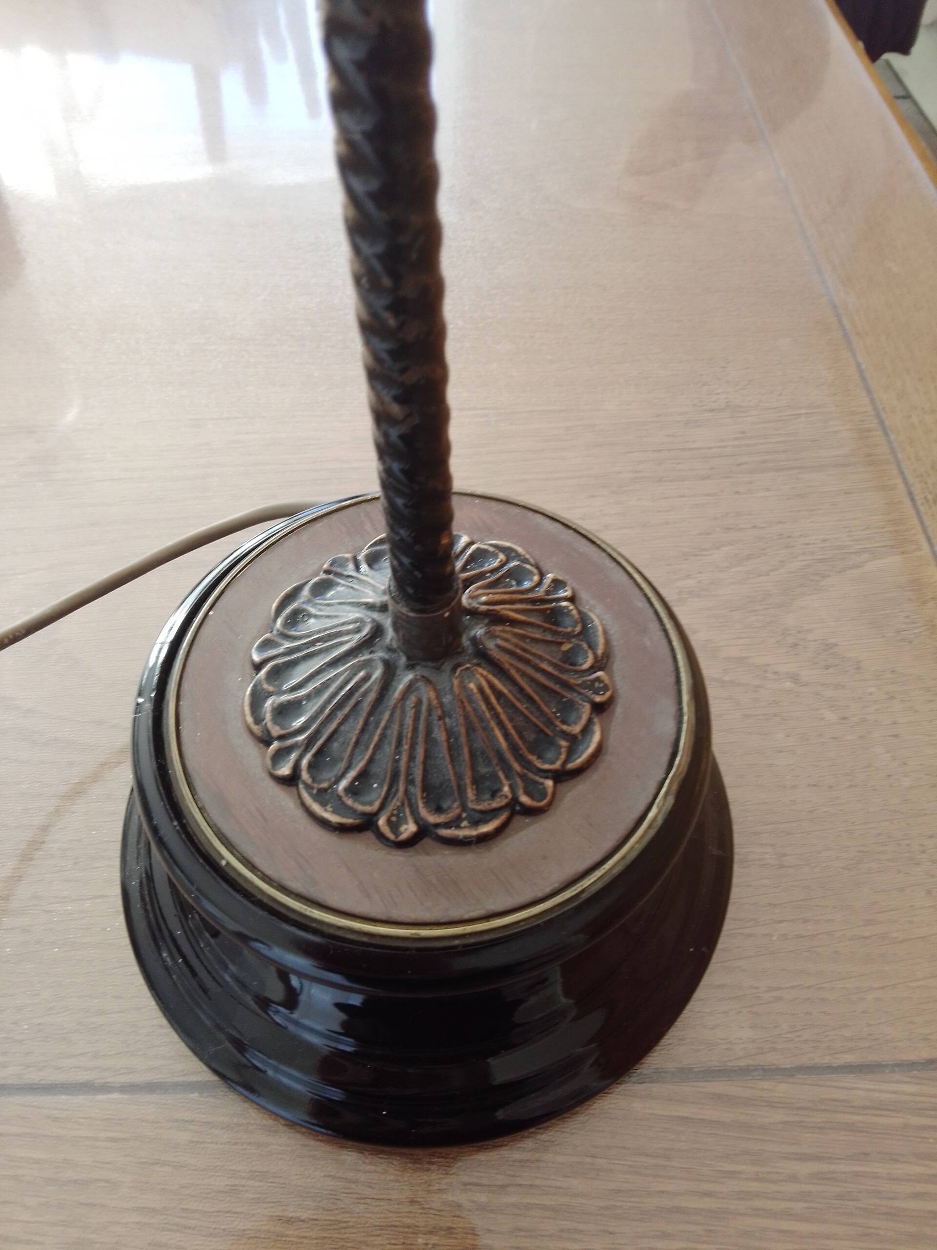 Old desk lamp with a small copper shade and a porcelain base.