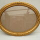 Large old oval gilded wooden frame and stucco decorations