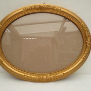 Large old oval gilded wooden frame and stucco decorations