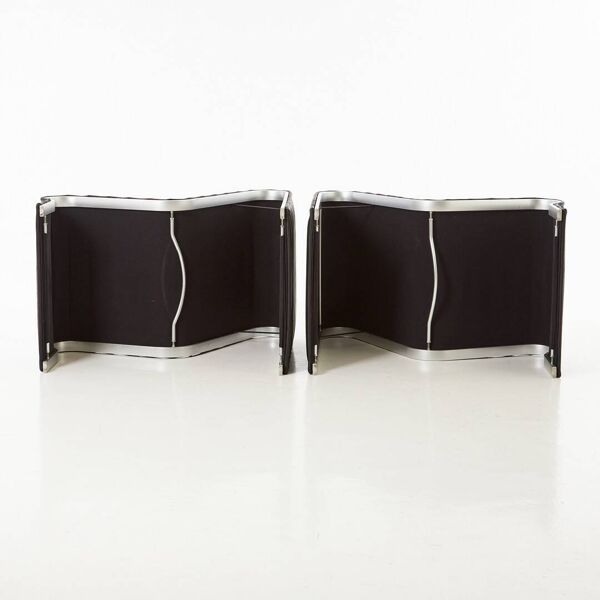 Modern black leather lounge chairs with an aluminium frame.