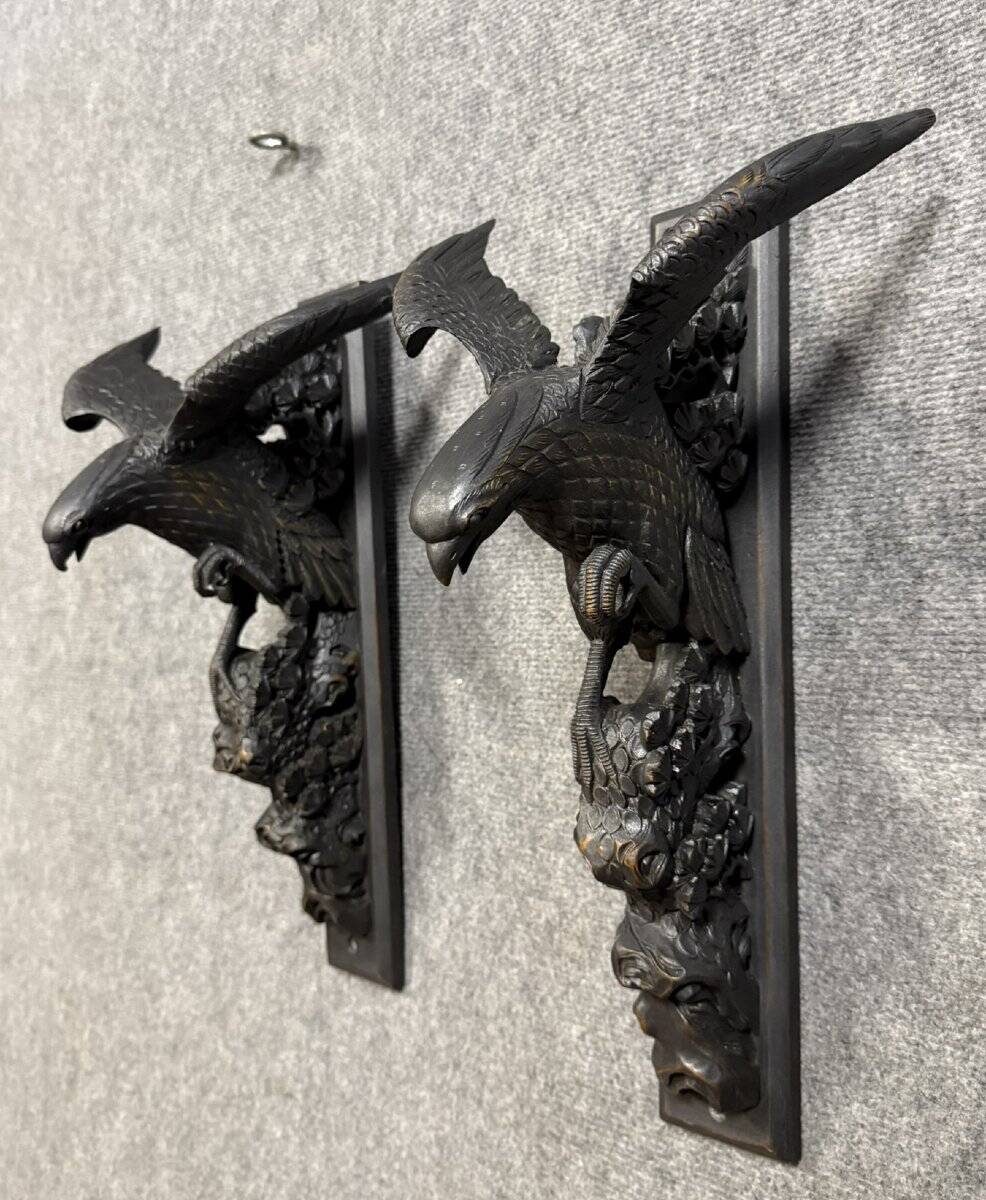 Rare pair of patinated wooden wall consoles, featuring two eagles with outstretched wings.