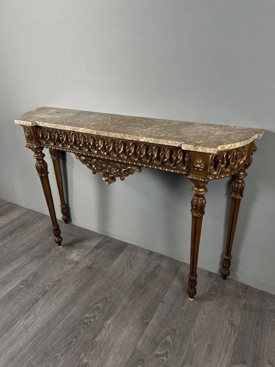 Louis XVI style console in carved wood with a gilded patina, 19th century.