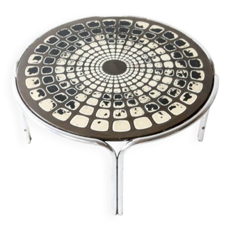 Black and white round coffee table with a mandala top and chrome metal base.