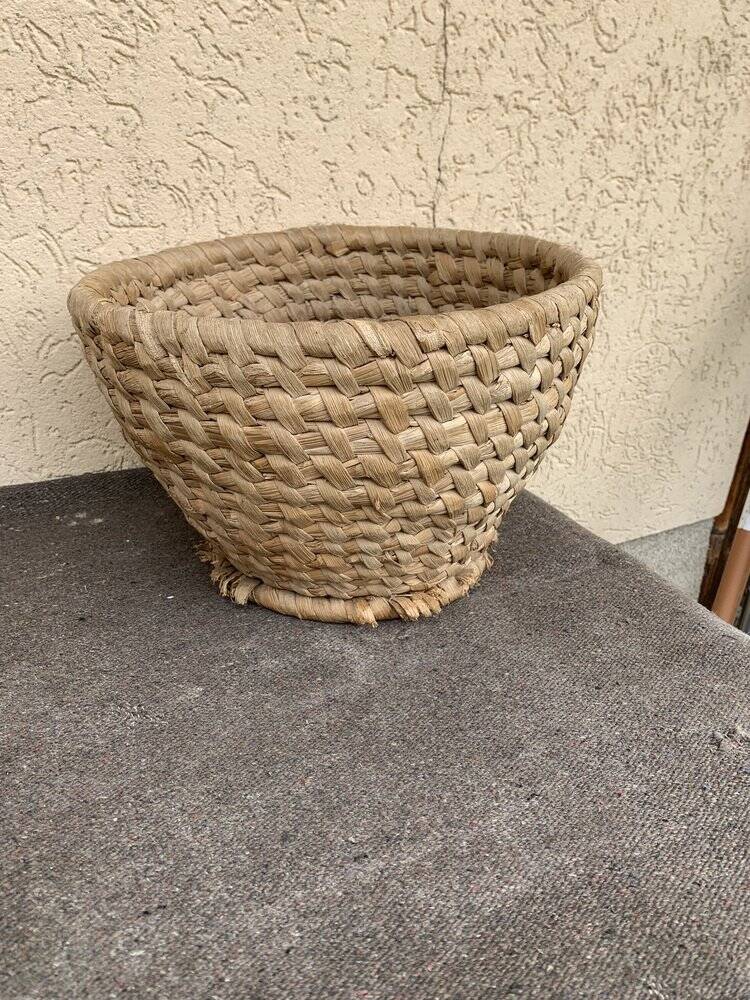 Brown woven wicker basket for collecting eggs — France, 1940s