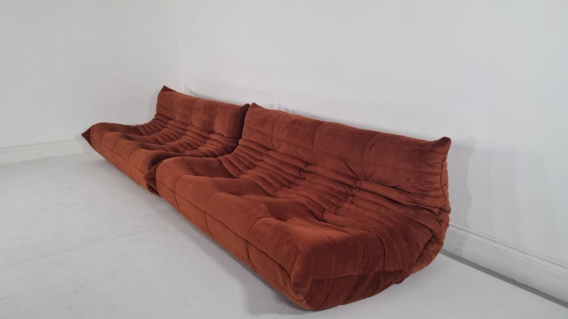 Ligne Roset Pair of 3-seater Togo sofas in rust velvet