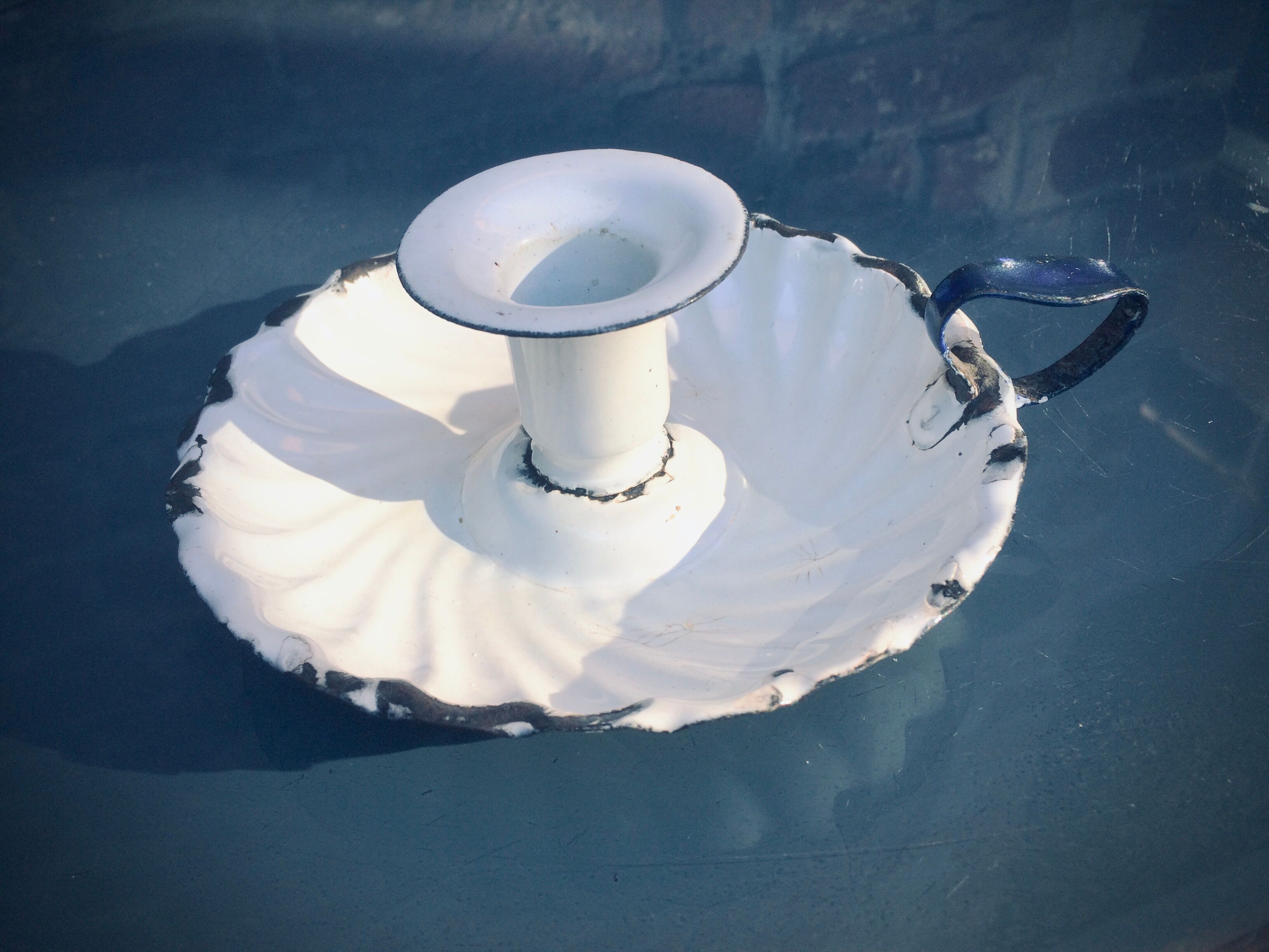 Old white enamelled candlestick