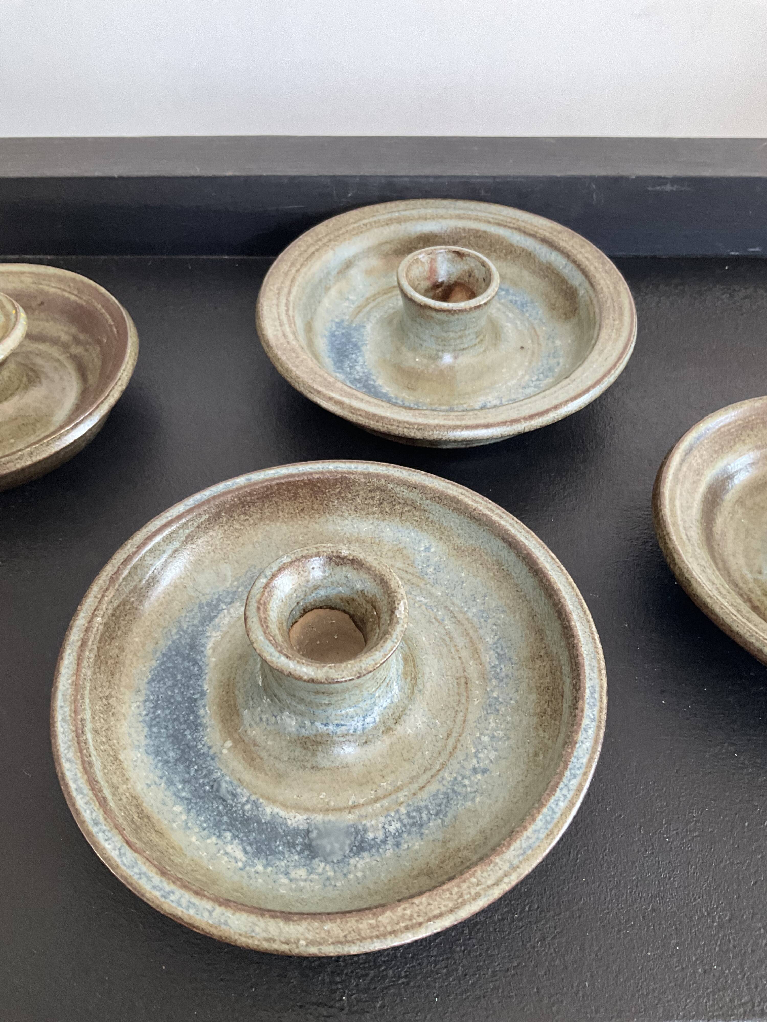 Series of 4 vintage stoneware candle holders
