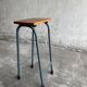 Upcycled industrial laboratory stool, black/grey metal frame with natural wood seat, mid-20th century