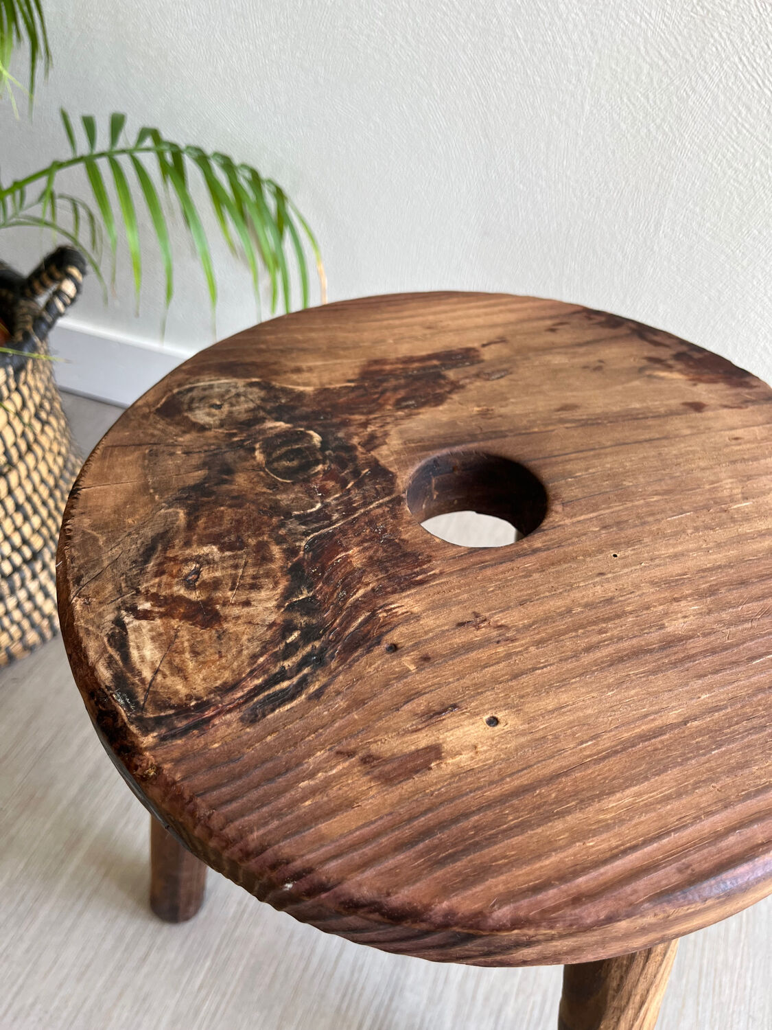 Three-legged wooden stool