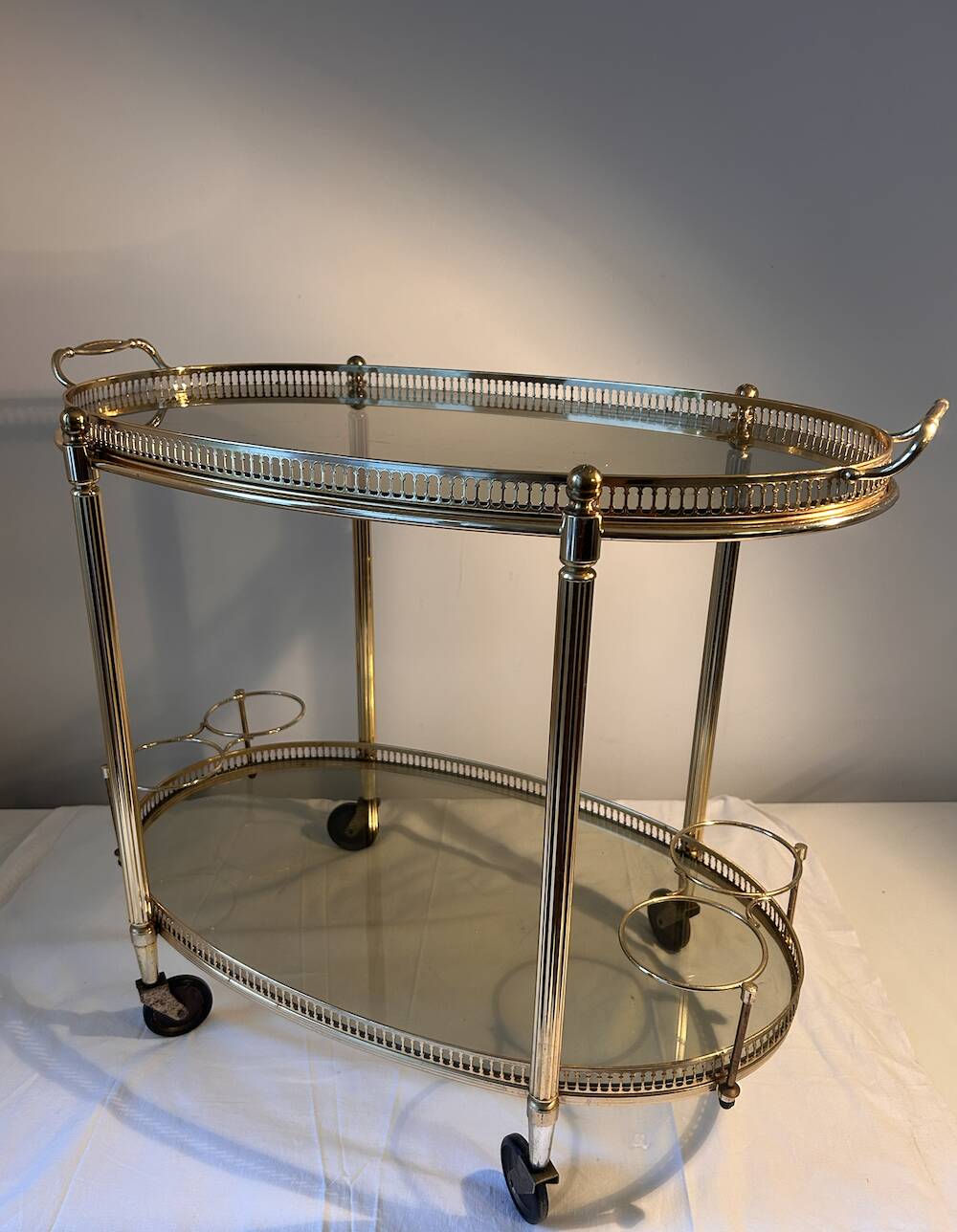 Neoclassical bar cart in gilded brass and smoked glass