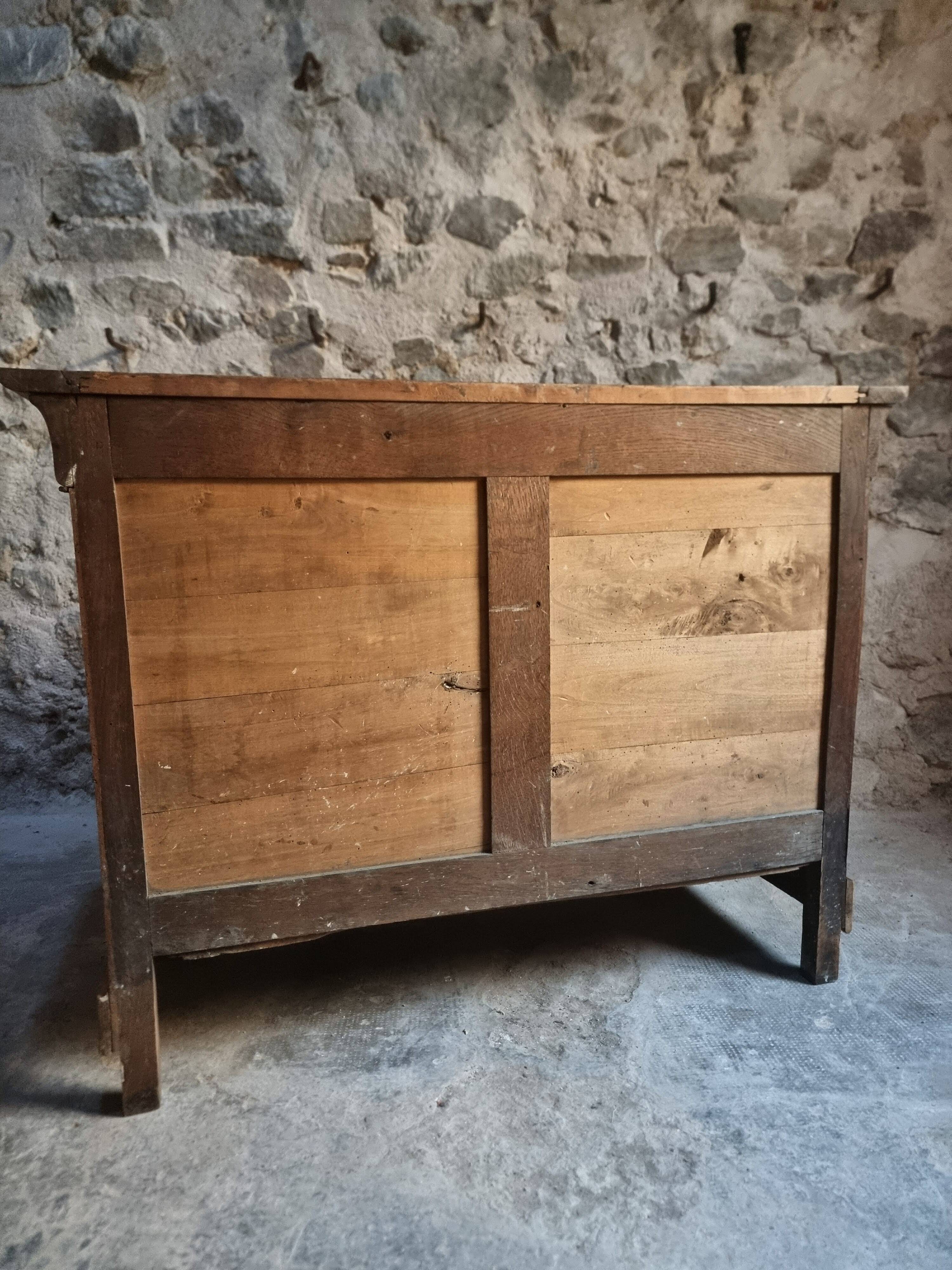 French antique walnut commode with a dark grey marble top, circa 1830–1860.