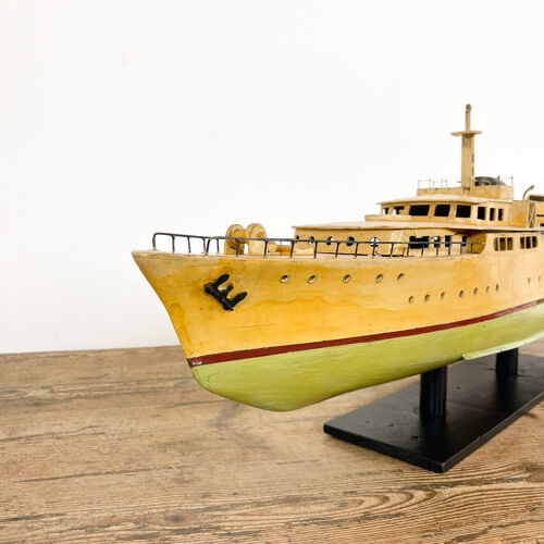 Vintage painted wooden model boat with motor