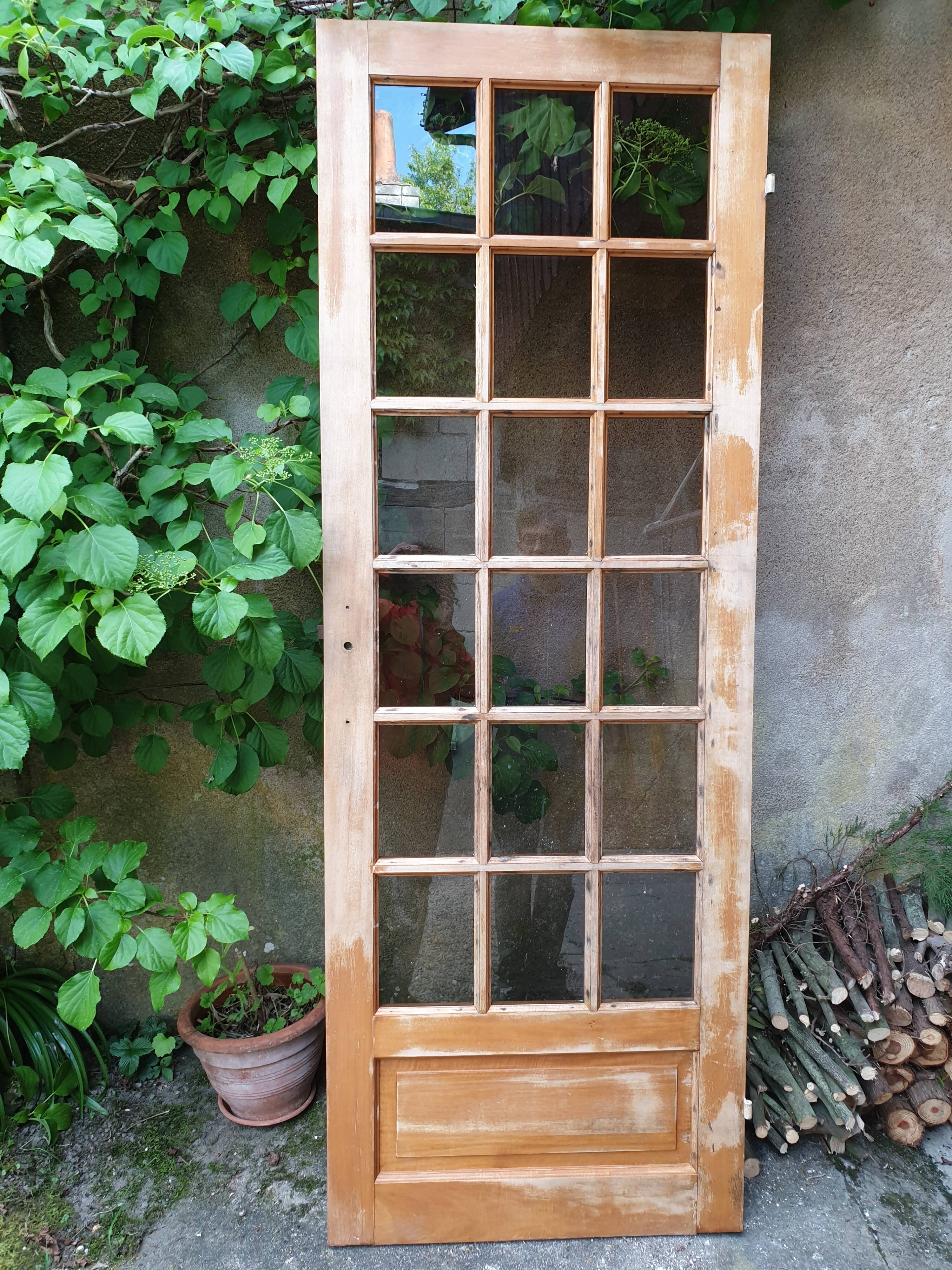 Old wooden door glazed with small tiles