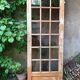 Old wooden door glazed with small tiles