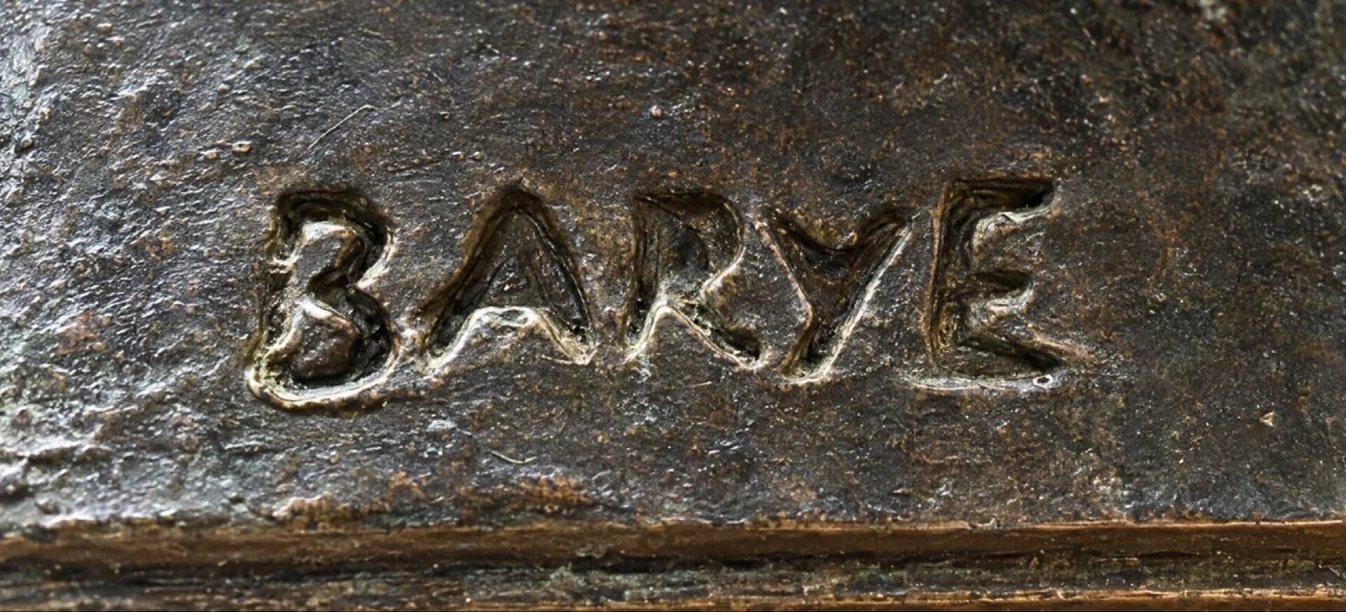 Bronze lion in motion with a brown patina, signed barye.