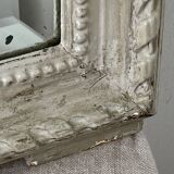 Large antique beveled mirror in carved wood painted with floral decoration and