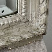 Large antique beveled mirror in carved wood painted with floral decoration and