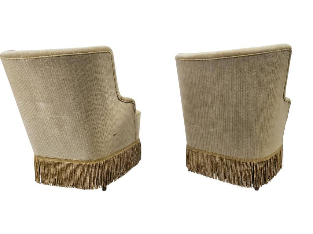 Set of 2 vintage 'gold' armchairs with fringes.