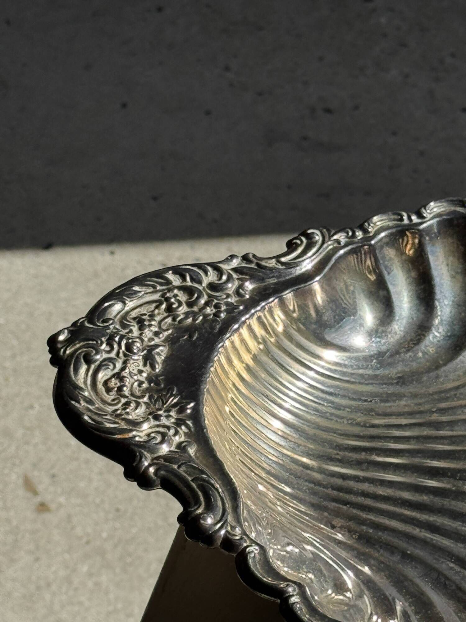 Large antique silver-plated bowl in the shape of a shell.