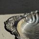 Large antique silver-plated bowl in the shape of a shell.