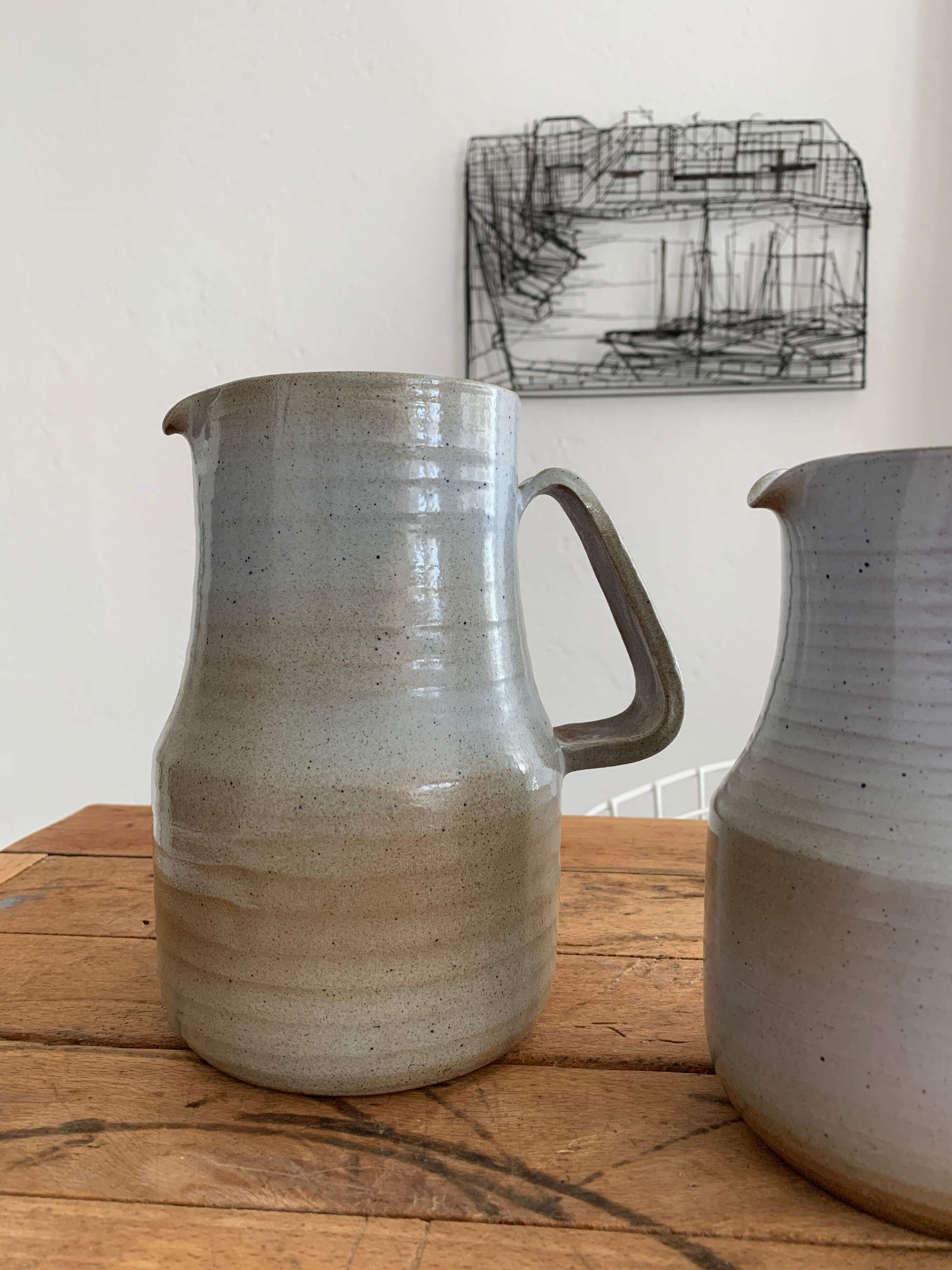 Pair vintage enamelled ceramic pitchers