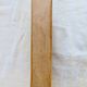 Vintage wooden coat rack with two round hooks.
