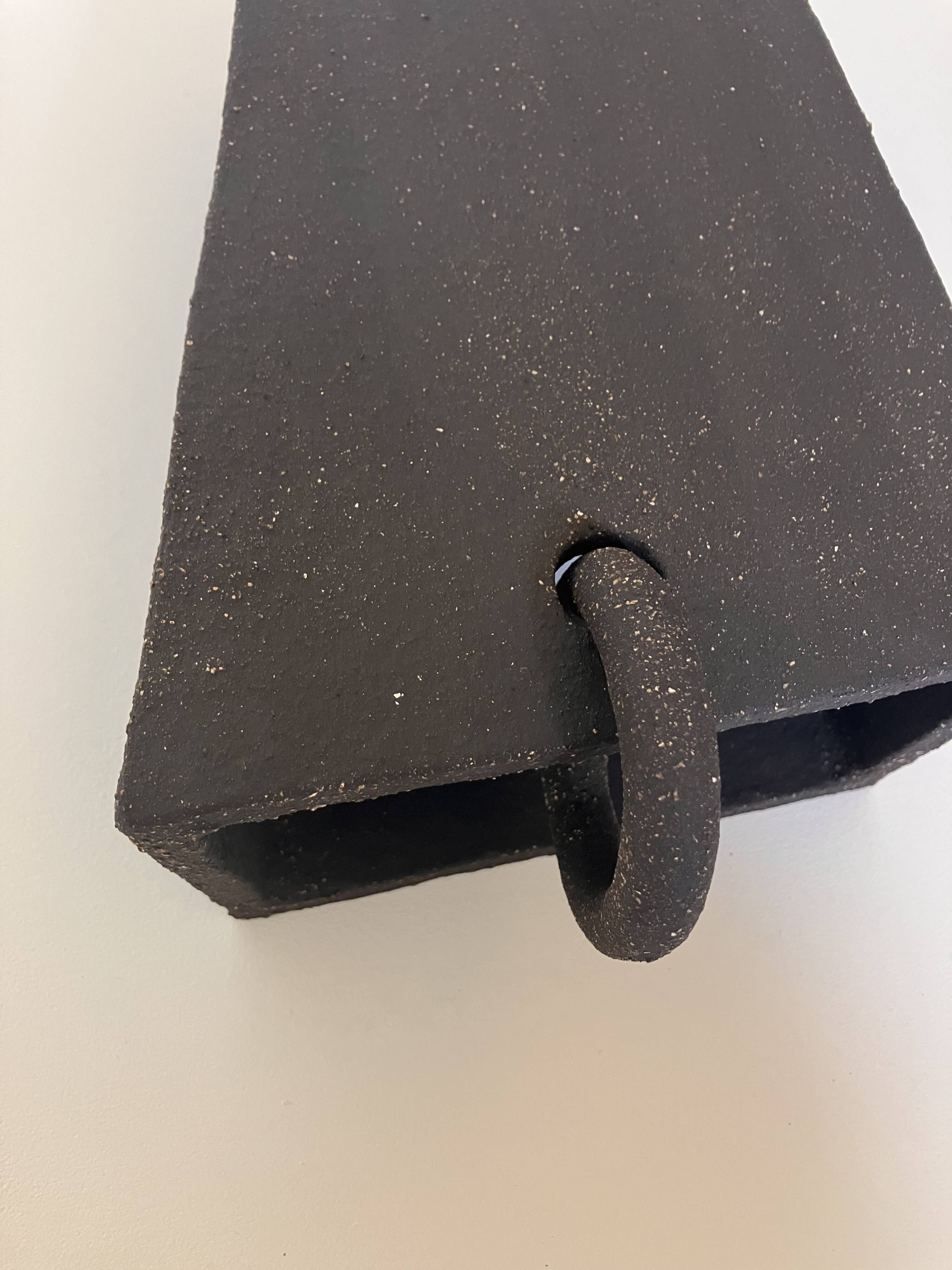 Pair of black stoneware graphic wall lights with handmade ring.