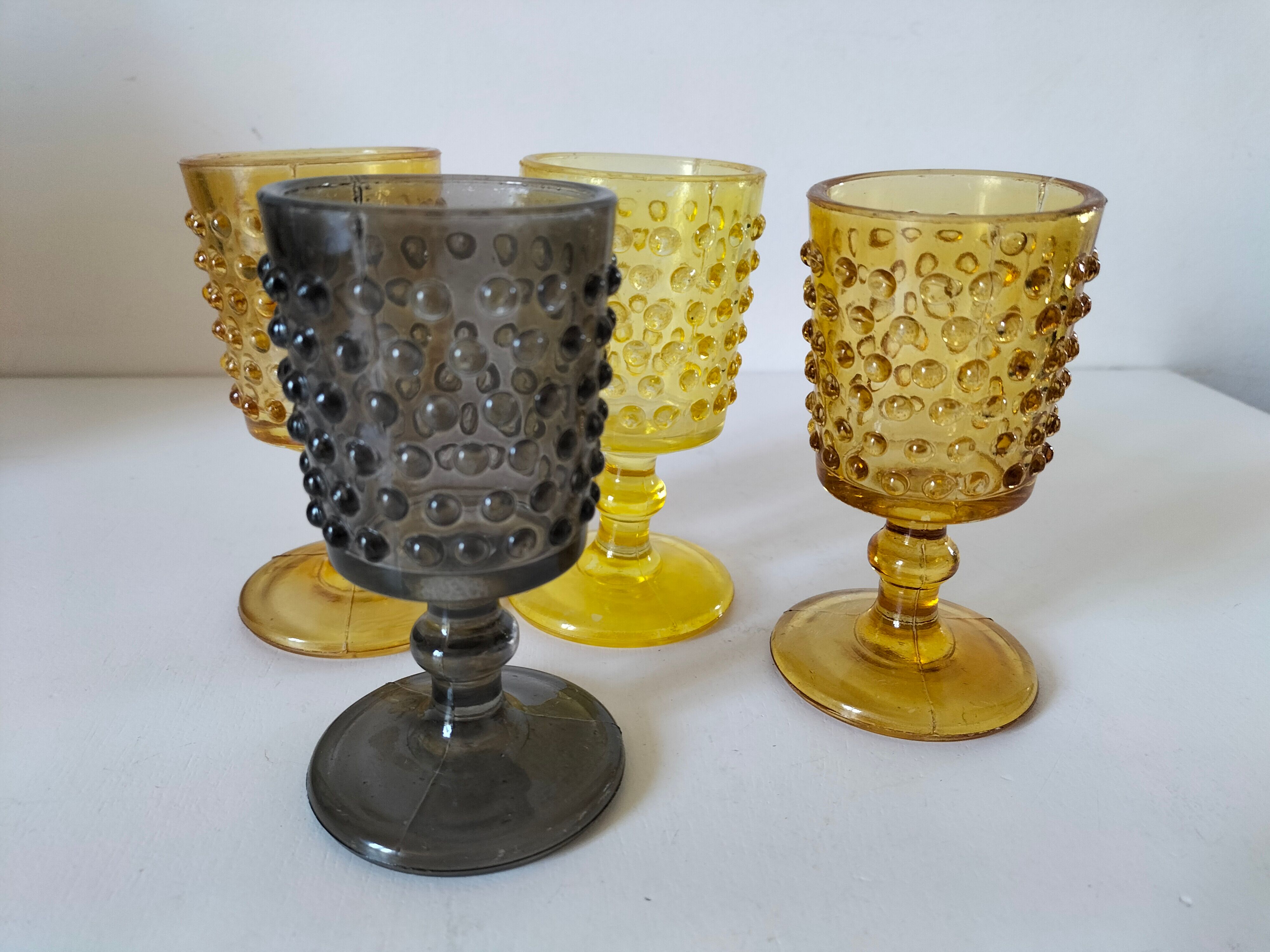 4 vintage stemmed glasses in hobnail glass and smoke colour.