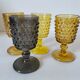 4 vintage stemmed glasses in hobnail glass and smoke colour.