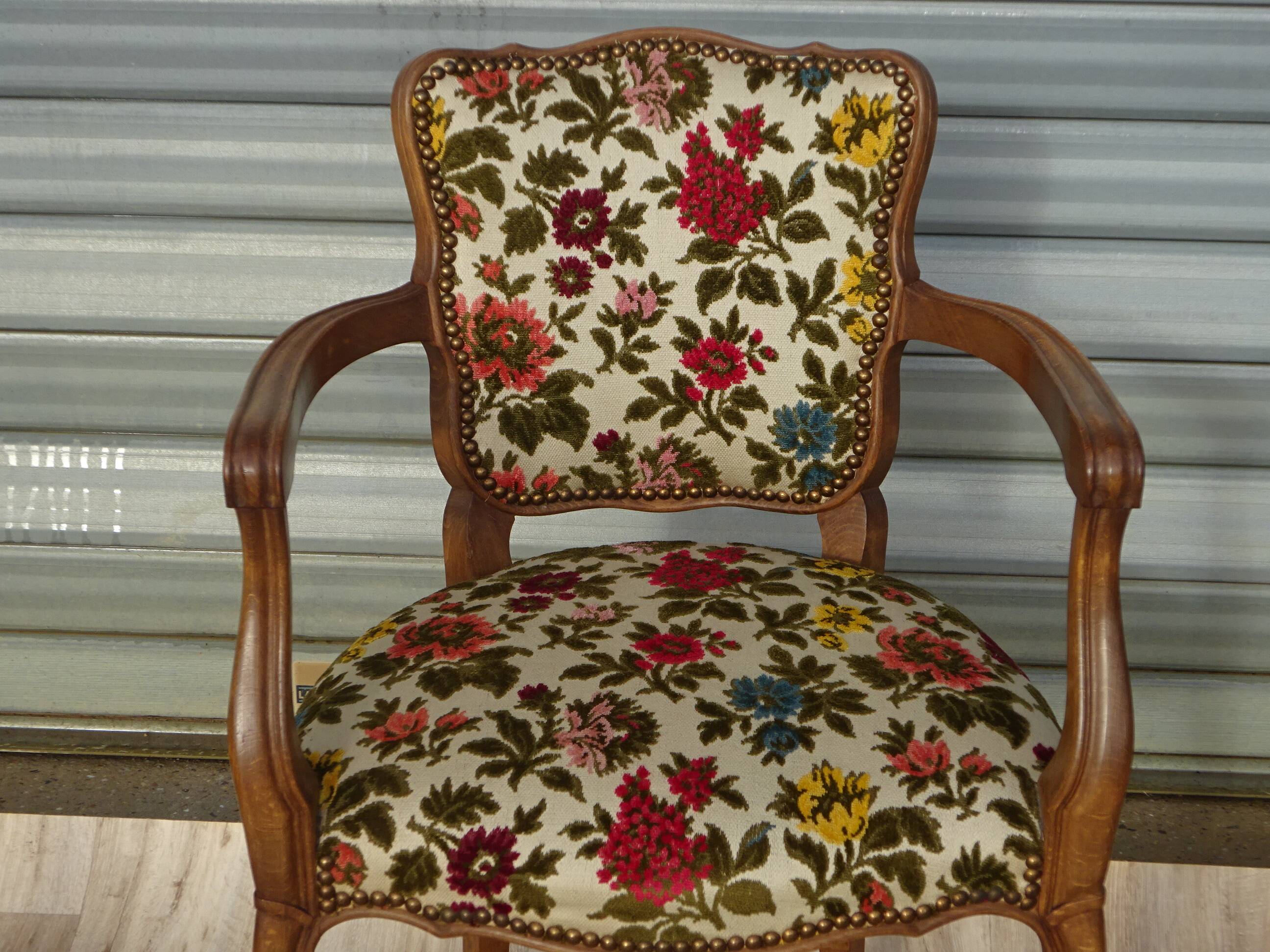Convertible armchair with brocade fabric and floral patterns.