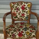 Convertible armchair with brocade fabric and floral patterns.