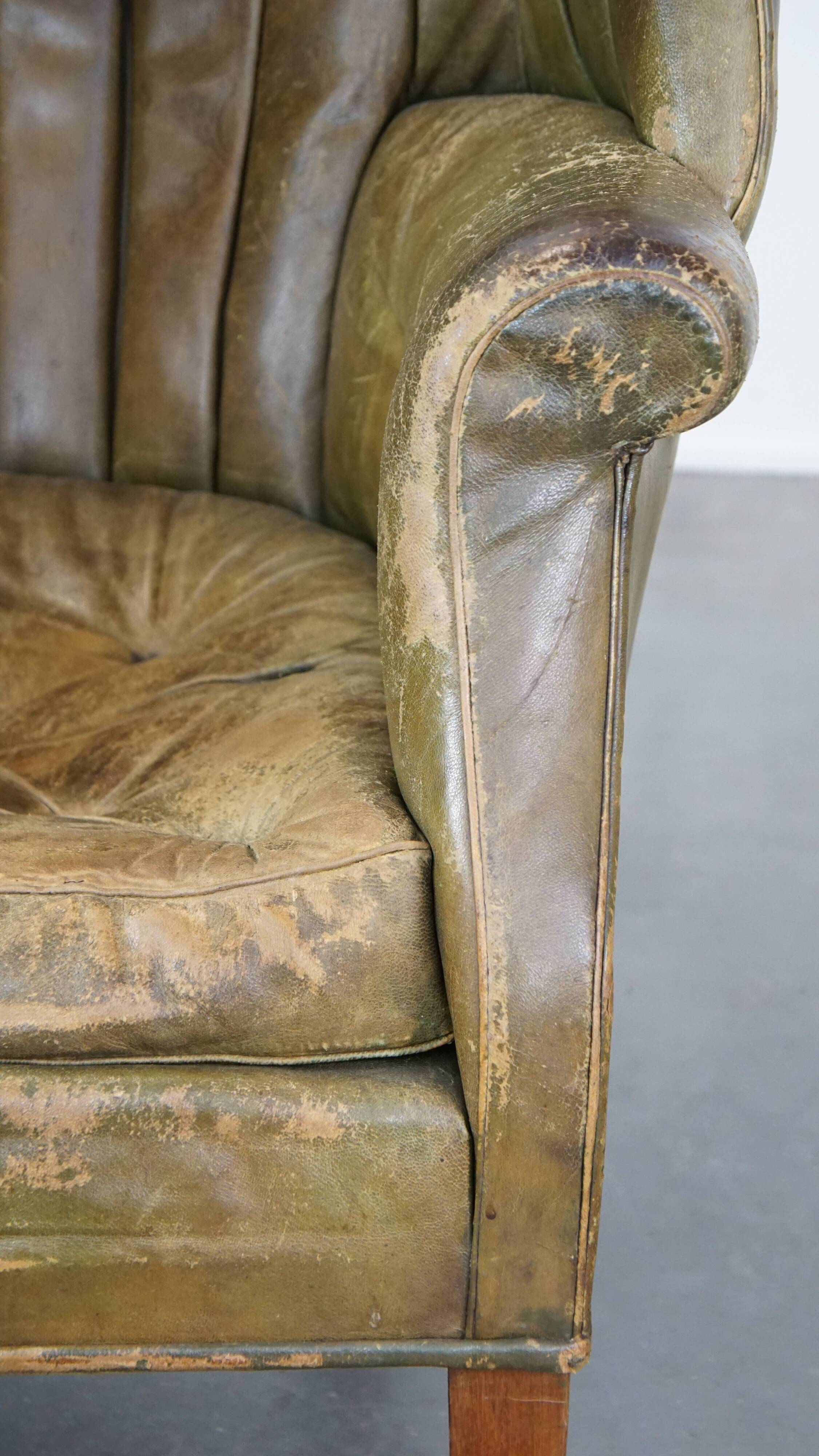 Green antique barrel back wingback chair on wheels
