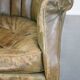 Green antique barrel back wingback chair on wheels