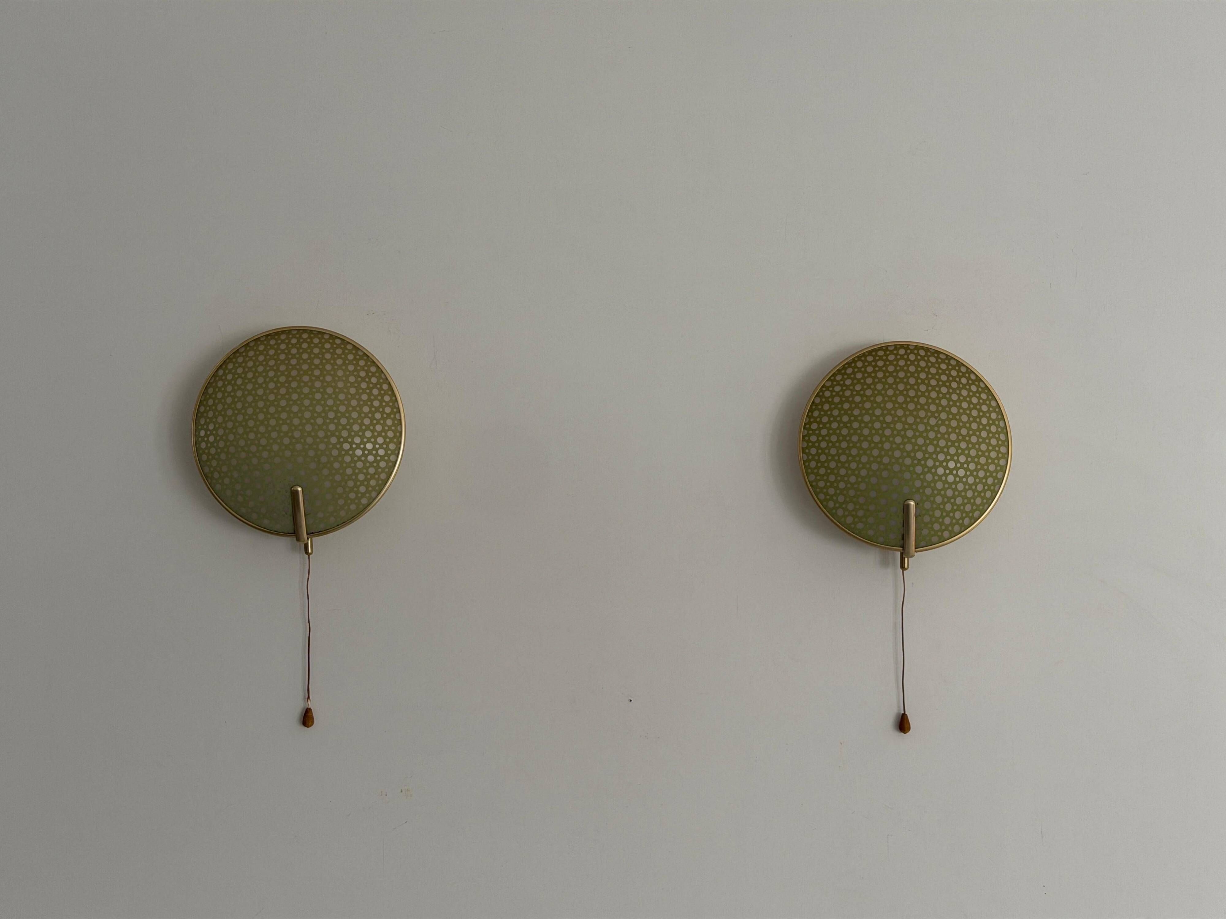 Pair of green plexiglass and gold metal wall lights by Erco, 1950s, Germany.