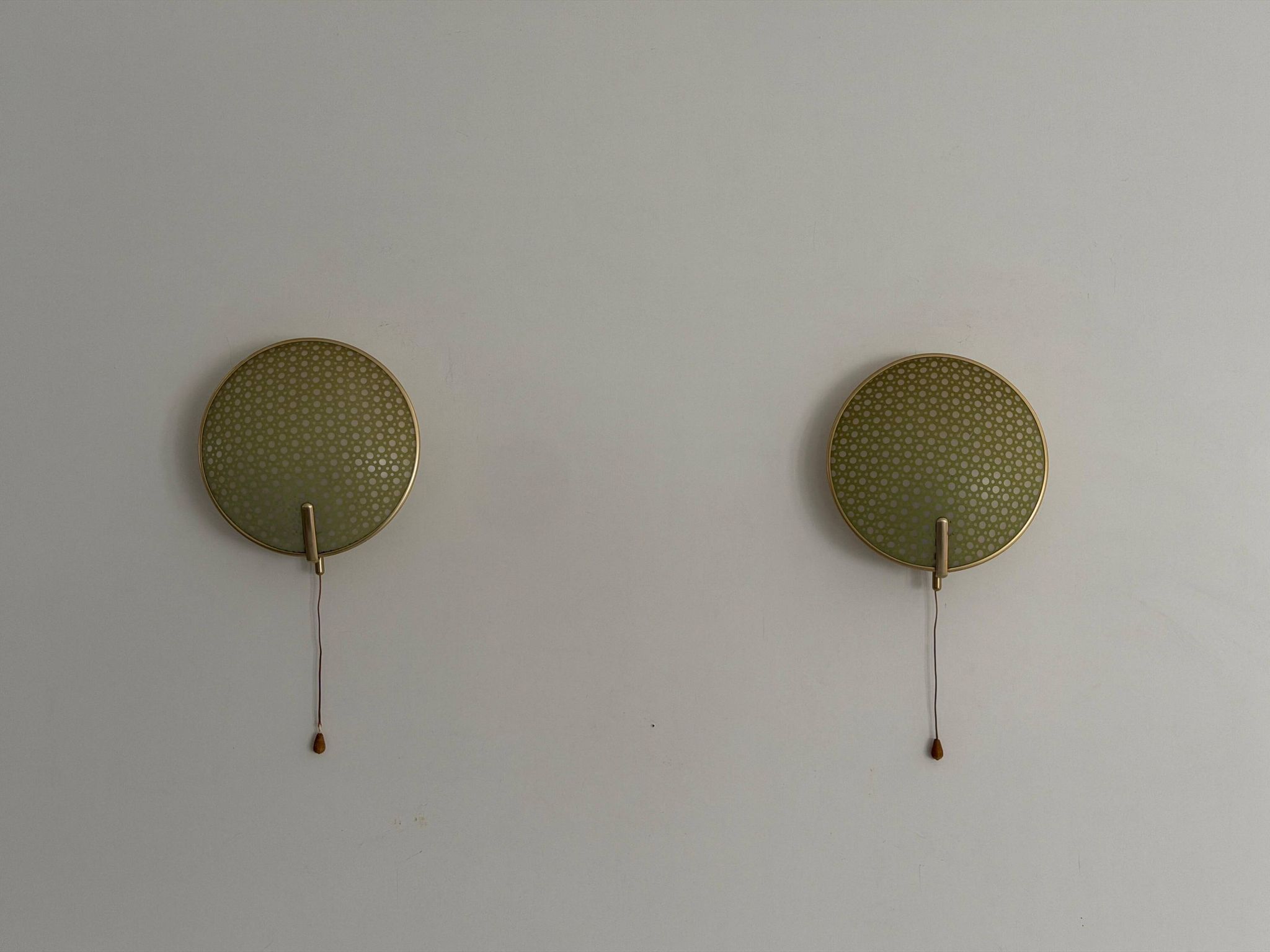 Pair of green plexiglass and gold metal wall lights by Erco, 1950s, Germany.