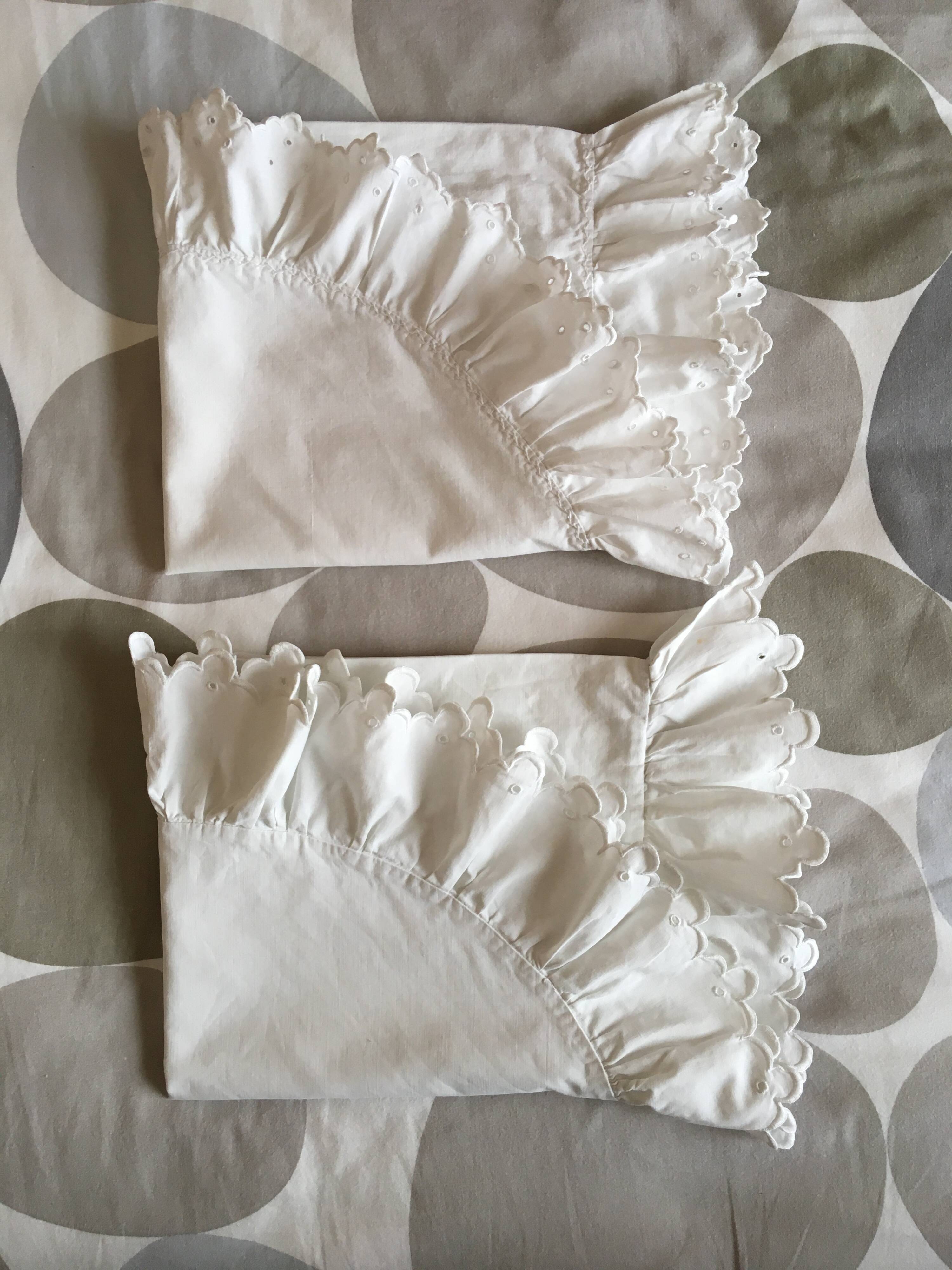 Two half-moon ruffled cushion covers