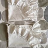 Two half-moon ruffled cushion covers