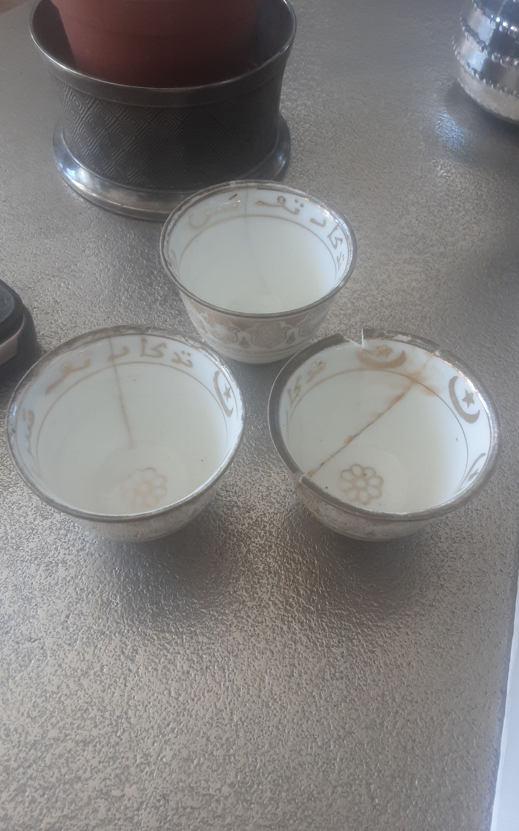 Old service porcelain brass cups