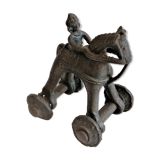 Old child's toy. Horse with bronze wheels. Ethnic object.