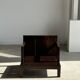 Small low armchair in varnished brown wood