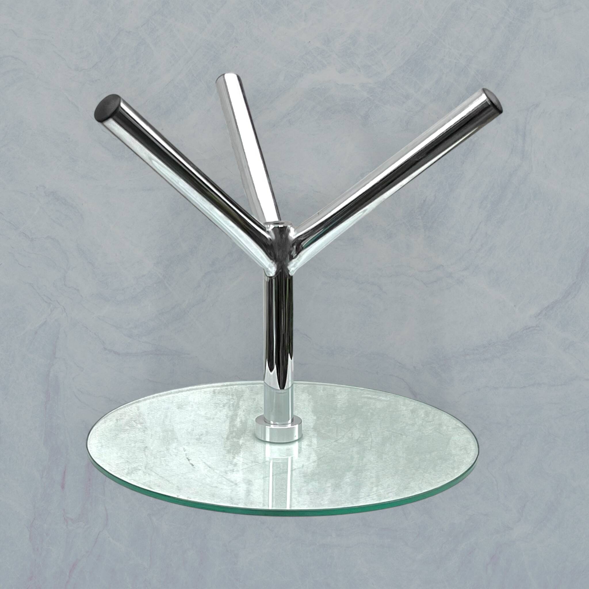 Modernist tripod side table in tempered glass and chrome metal.